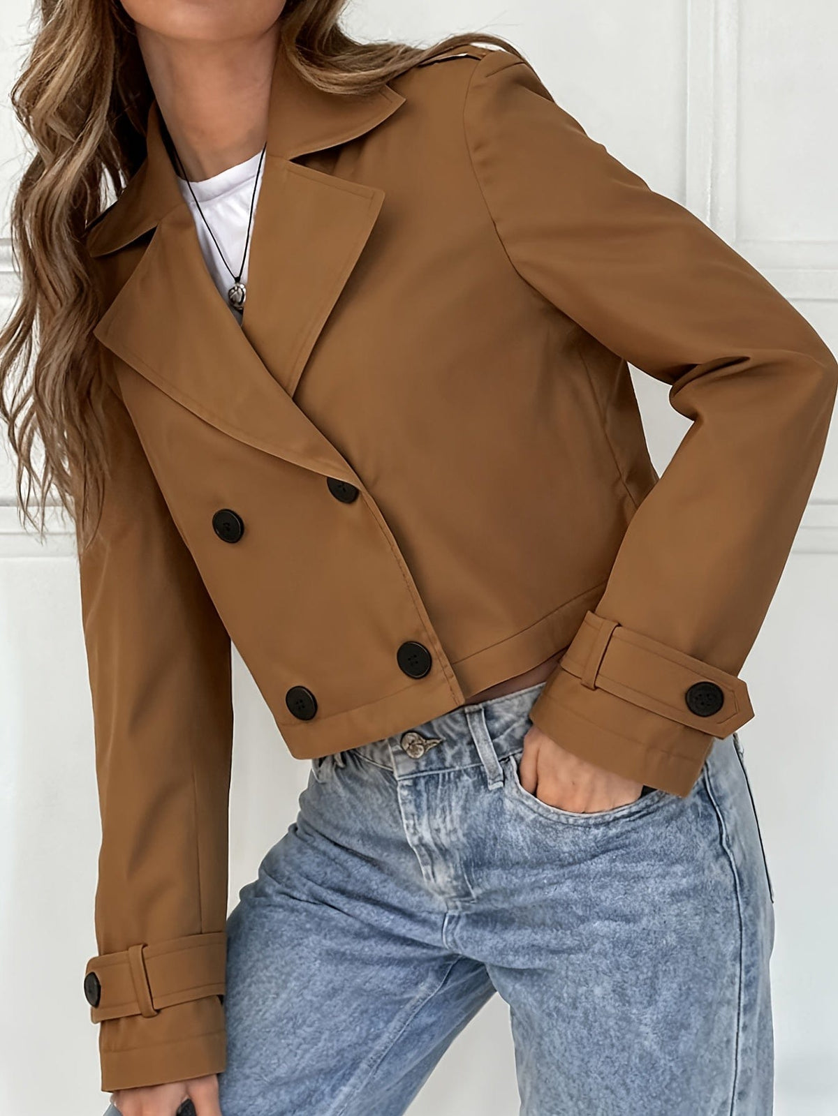Woman wearing a cropped double breasted pea coat with notched lapel over a white top and light blue jeans._6
