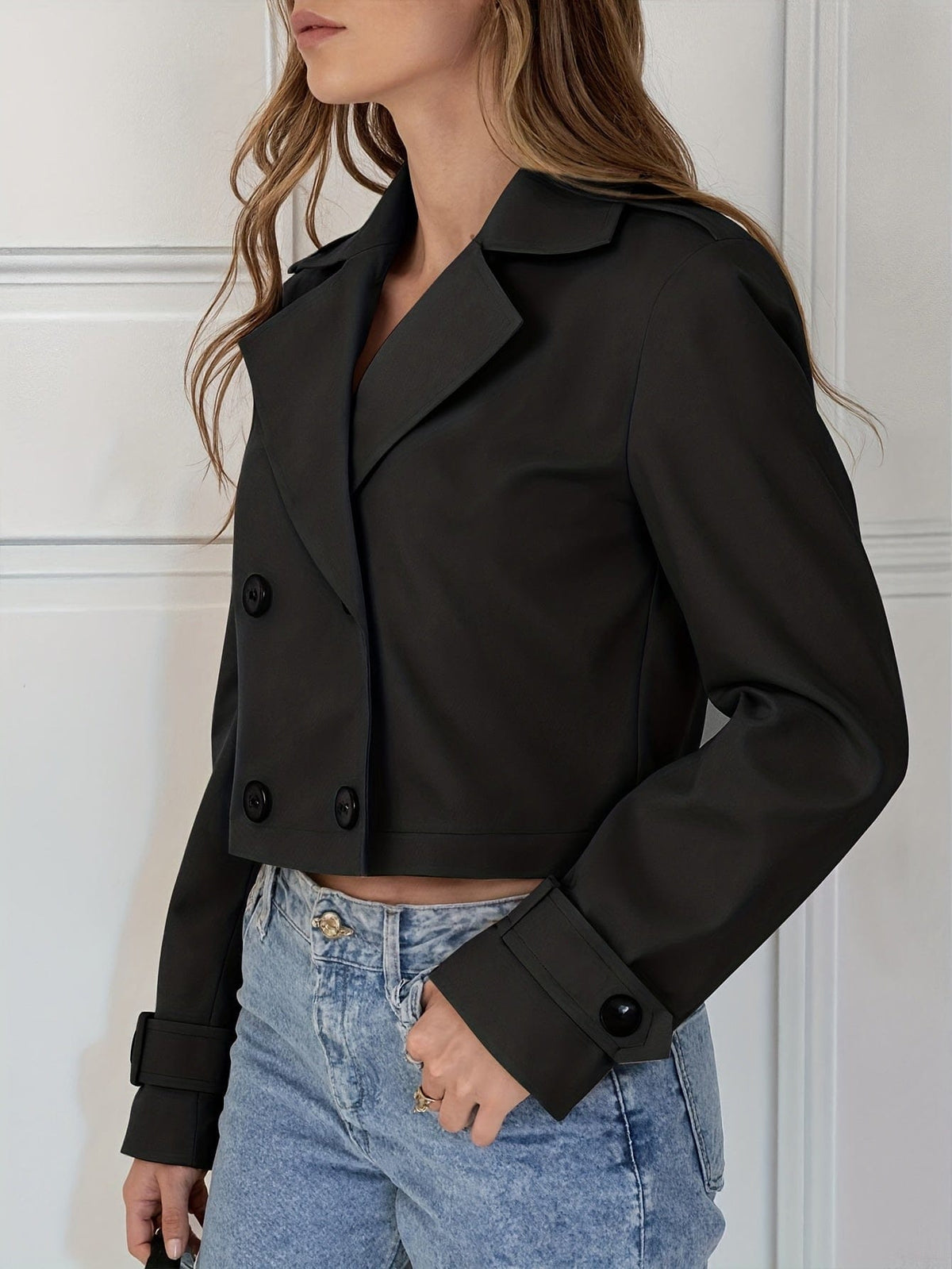Woman wearing a cropped double breasted pea coat with notched lapel over a white top and light blue jeans._7