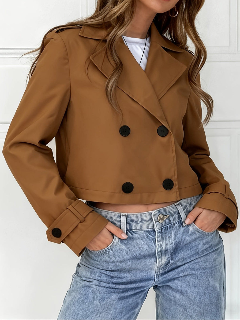 Woman wearing a cropped double breasted pea coat with notched lapel over a white top and light blue jeans._8