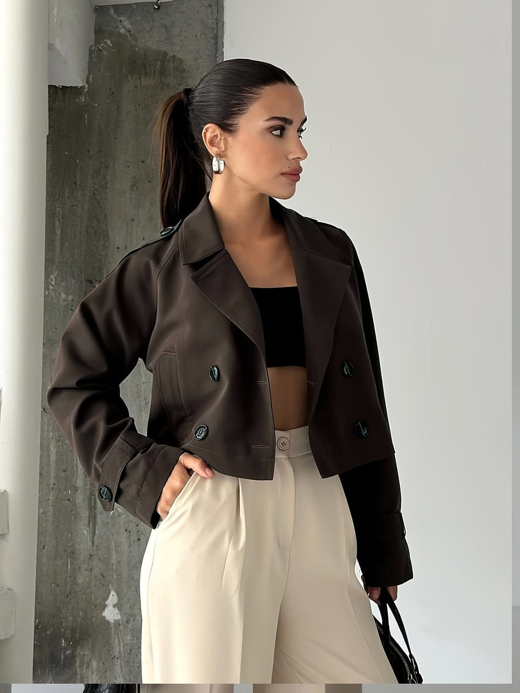 Woman wearing a cropped double breasted pea coat with notched lapel, long sleeves, and flap pockets, styled with high waisted trousers_0