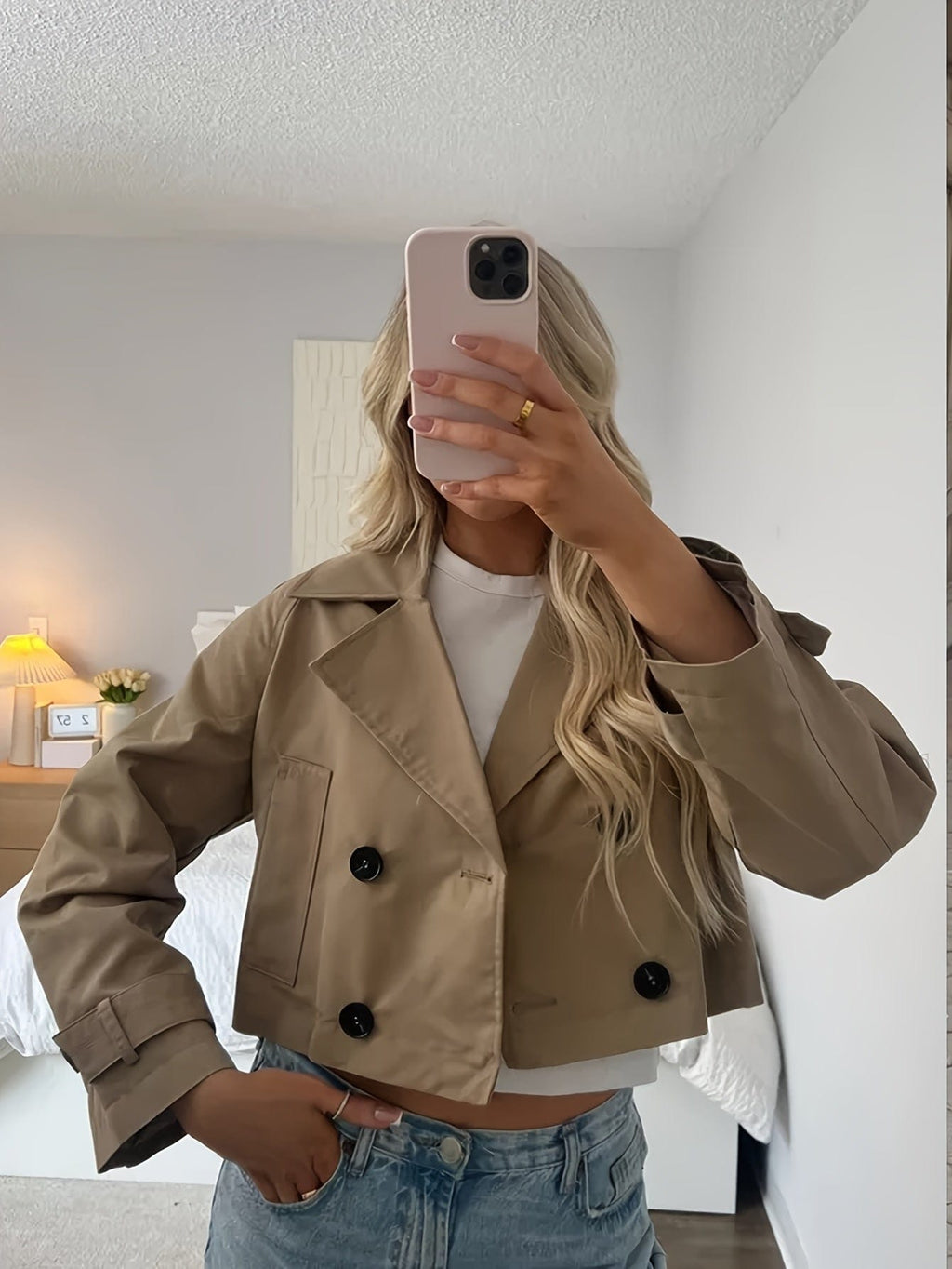 Woman wearing a cropped double breasted pea coat with notched lapel, long sleeves, and flap pockets, styled with high waisted trousers_1