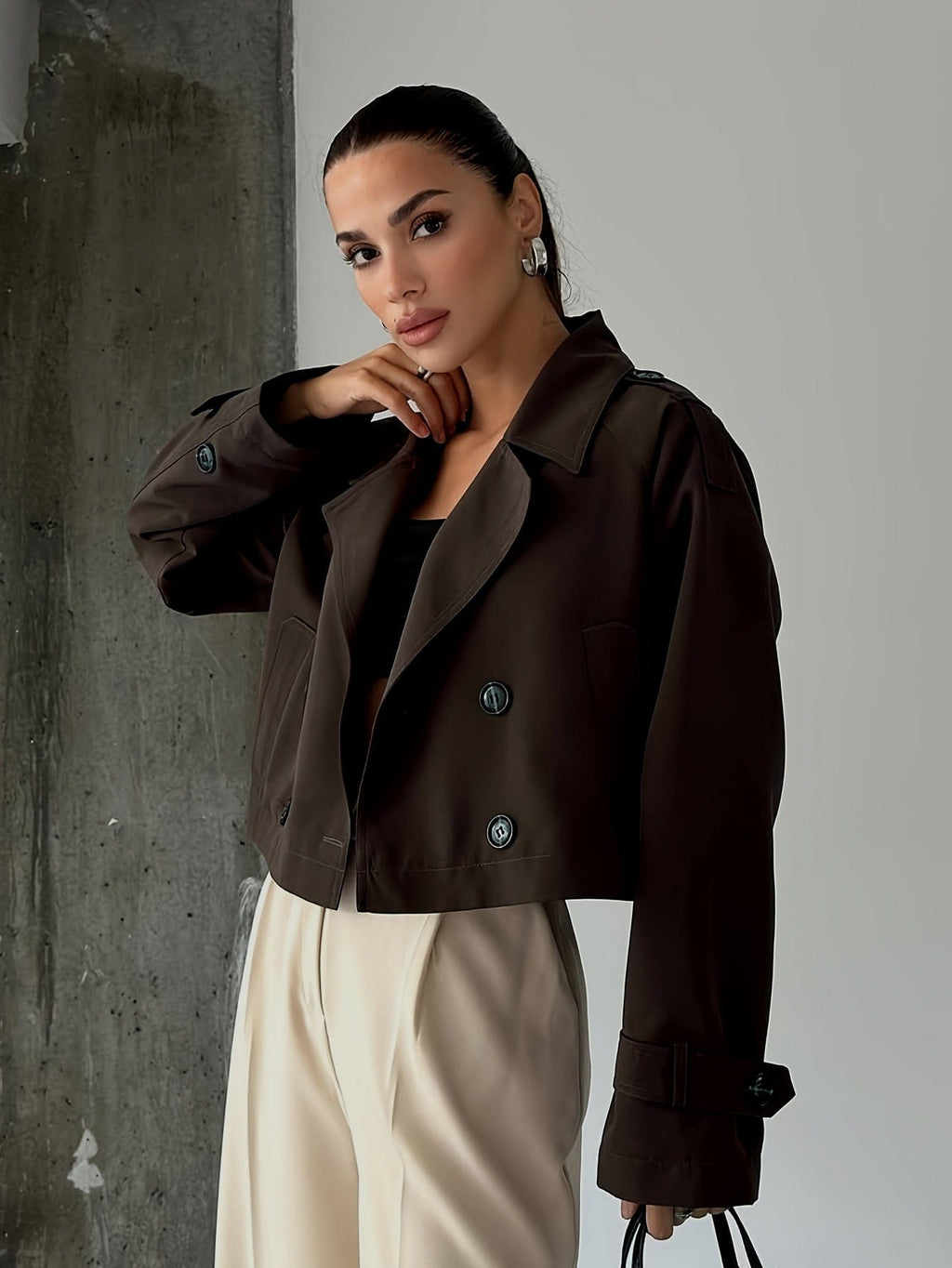 Woman wearing a cropped double breasted pea coat with notched lapel, long sleeves, and flap pockets, styled with high waisted trousers_2