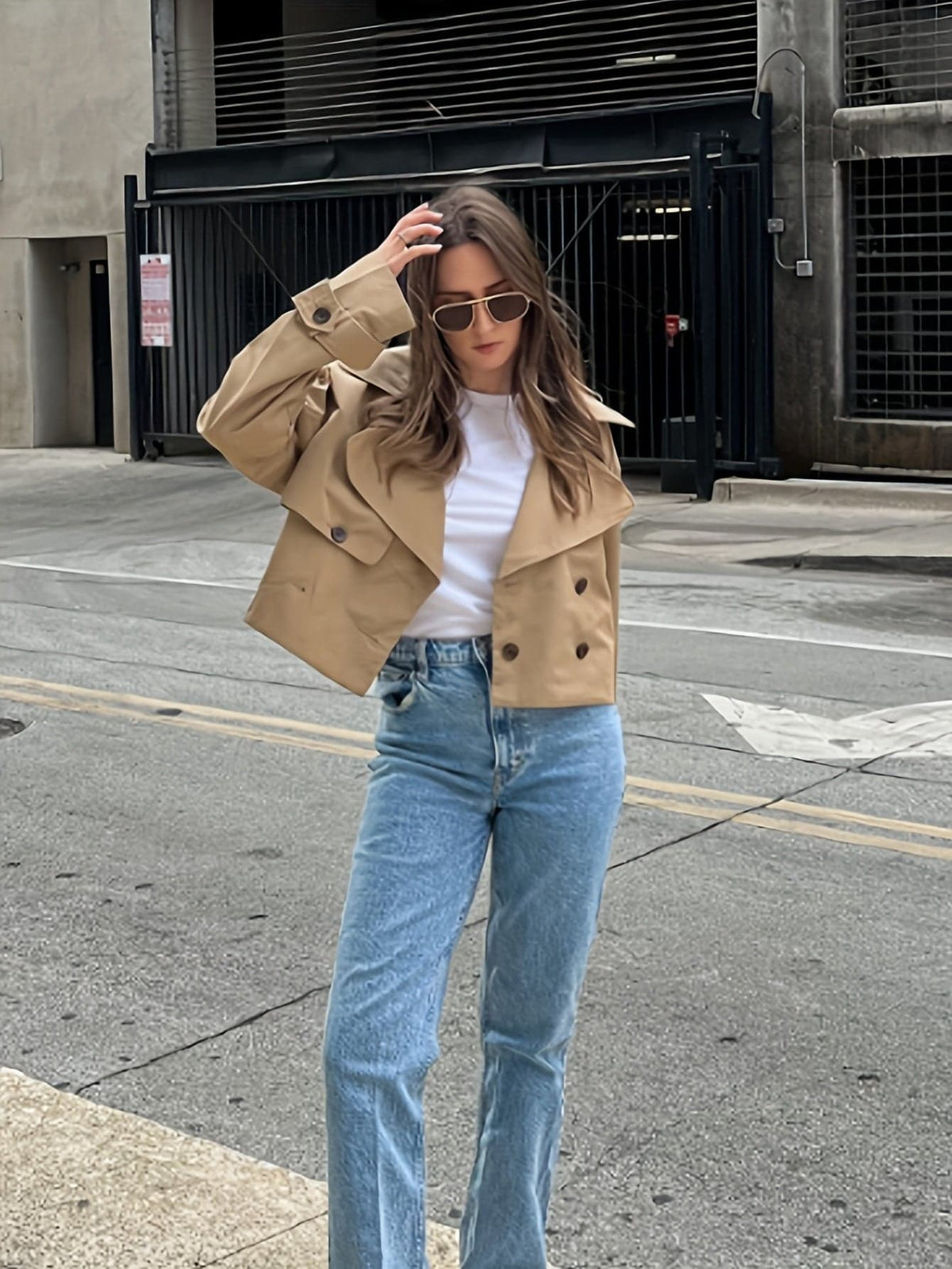 Woman wearing a cropped double breasted pea coat with notched lapel, long sleeves, and flap pockets, styled with high waisted trousers_3