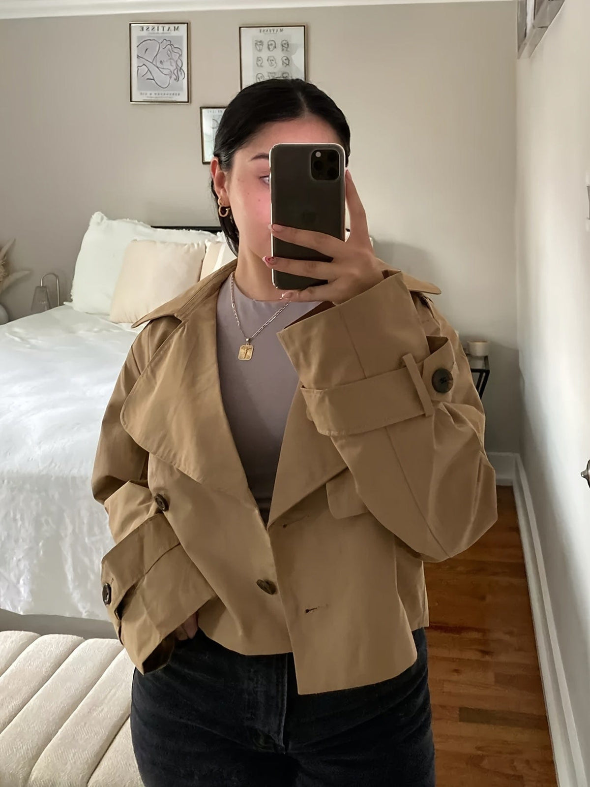 Woman wearing a cropped double breasted pea coat with notched lapel, long sleeves, and flap pockets, styled with high waisted trousers_7