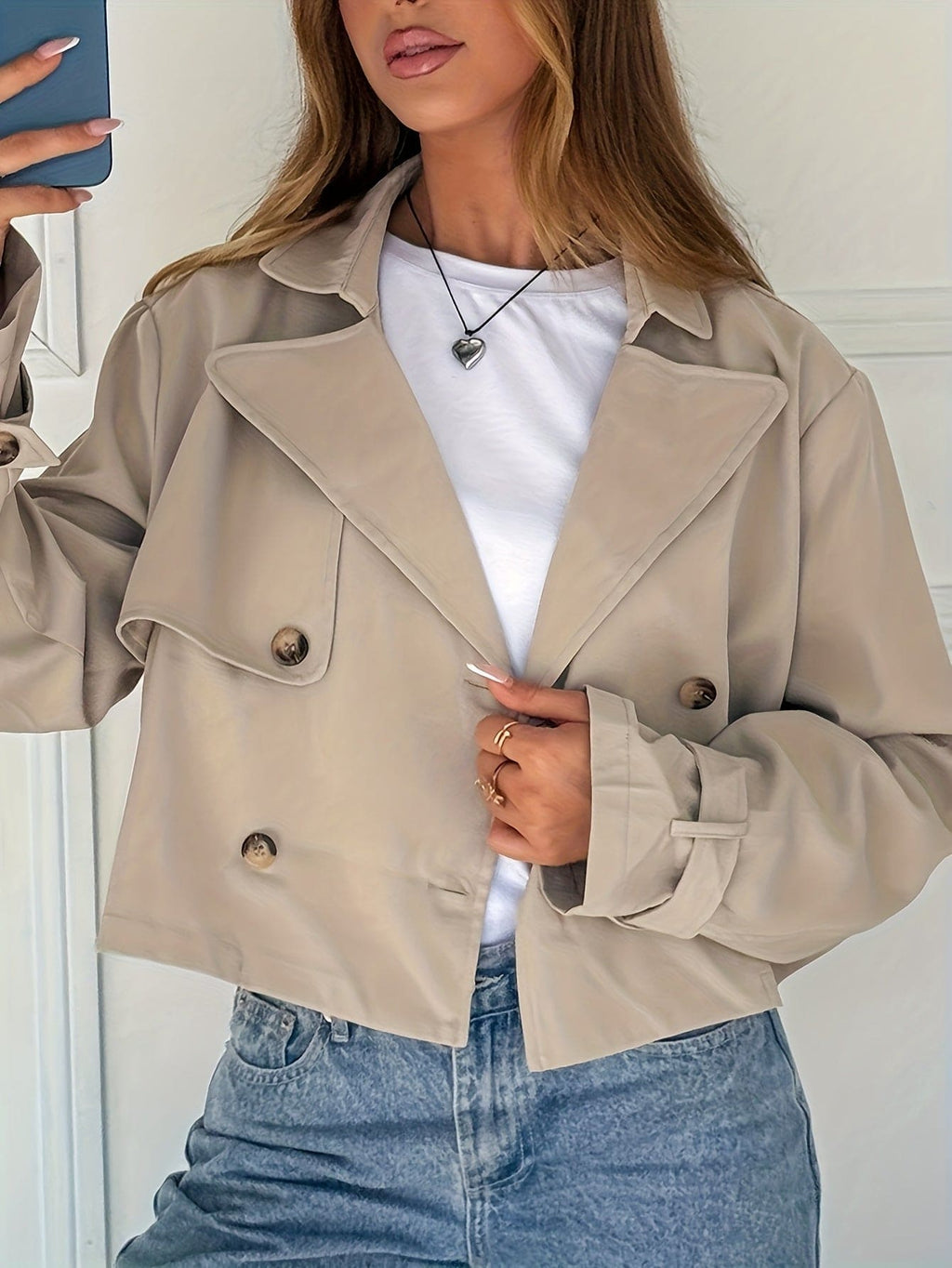 Woman wearing a cropped double breasted pea coat with notch lapel over a white tee and high waisted jeans._0