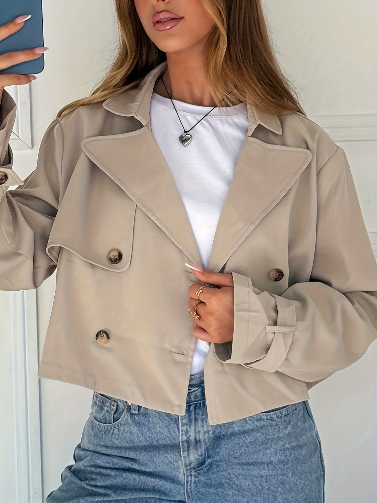 Woman wearing a cropped double breasted pea coat with notch lapel over a white tee and high waisted jeans._0