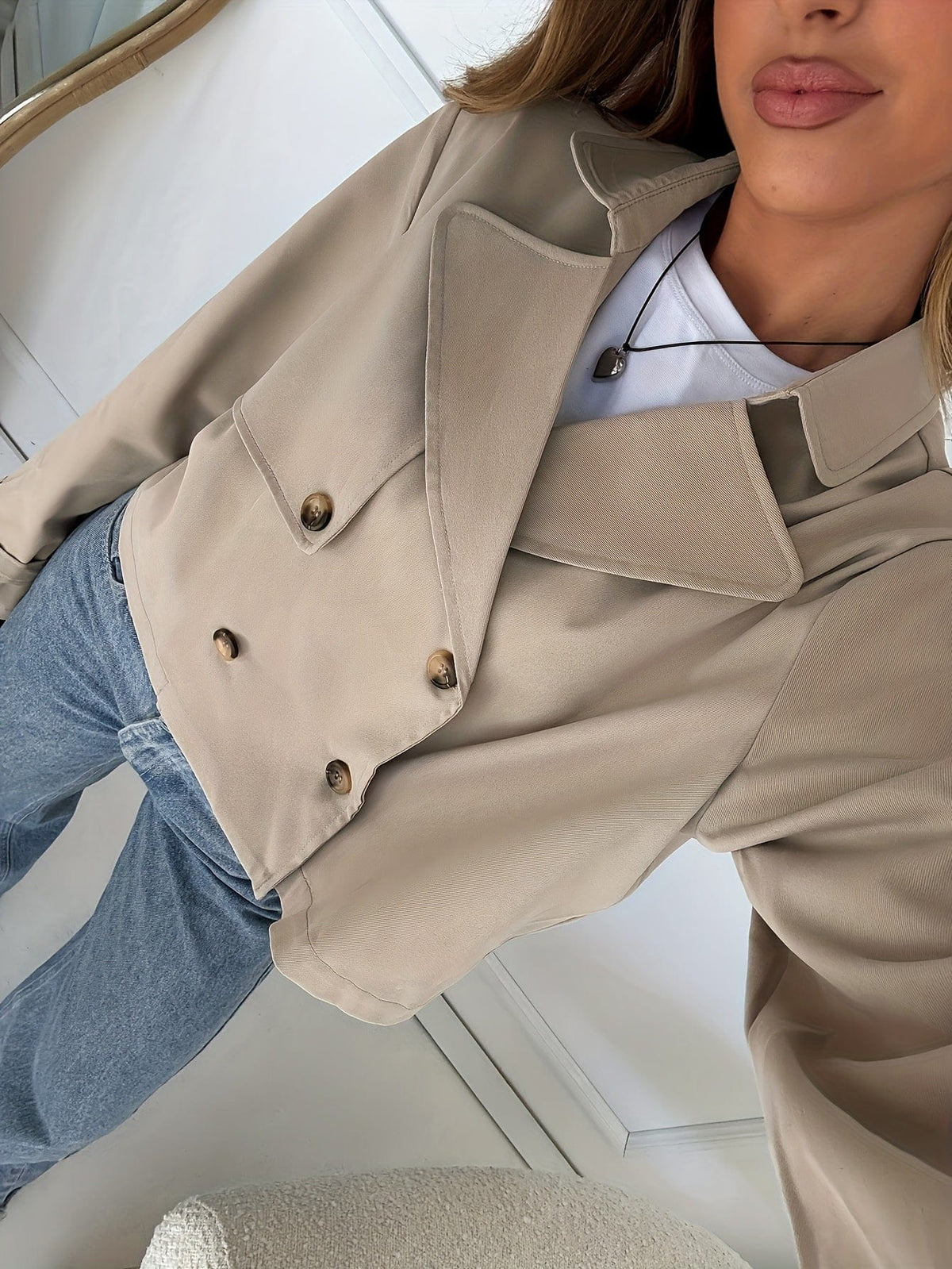 Woman wearing a cropped double breasted pea coat with notch lapel over a white tee and high waisted jeans._4