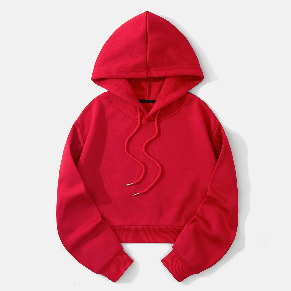 Vivid red cropped pullover hoodie shown flat with a raised hood, long sleeves, ribbed waistband, and adjustable drawstrings.