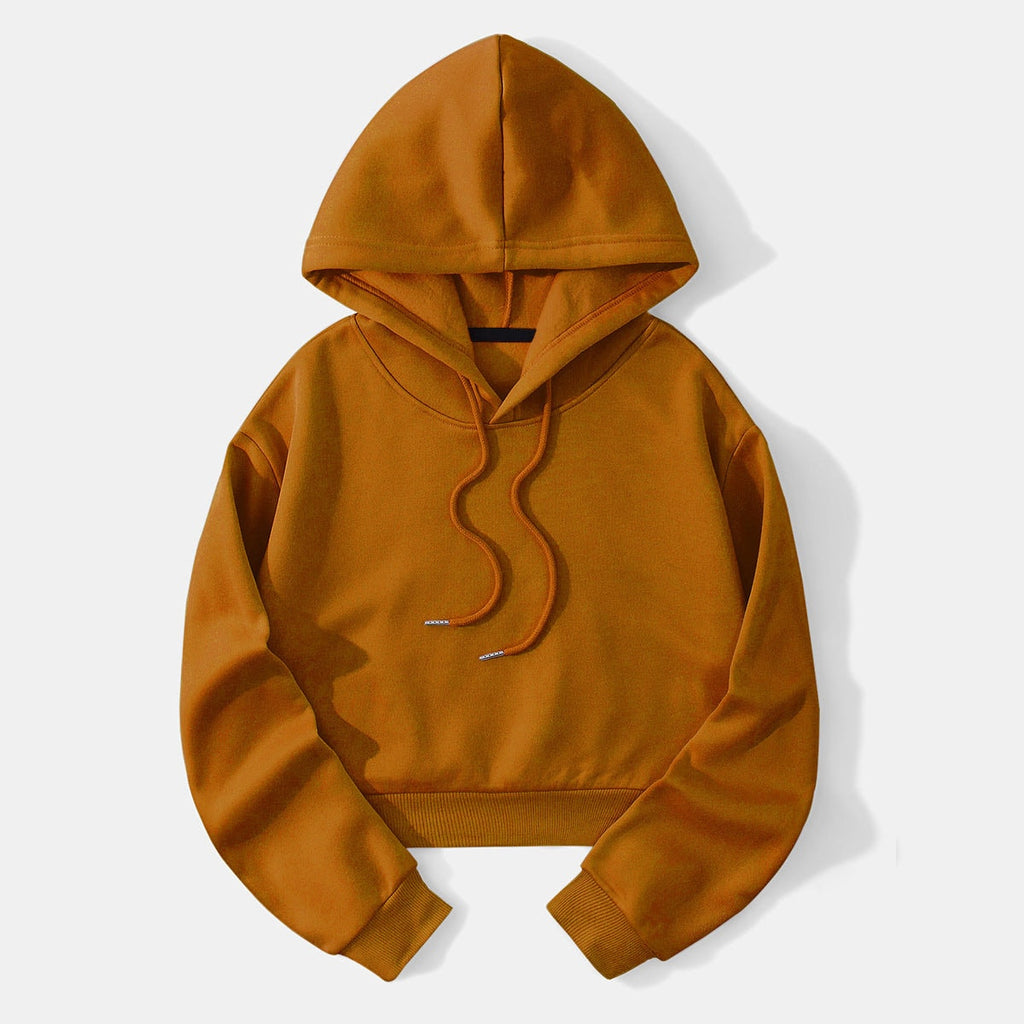 Mustard cropped drawstring hoodie displayed flat with its hood raised, long sleeves, ribbed hem, and matching drawstrings.