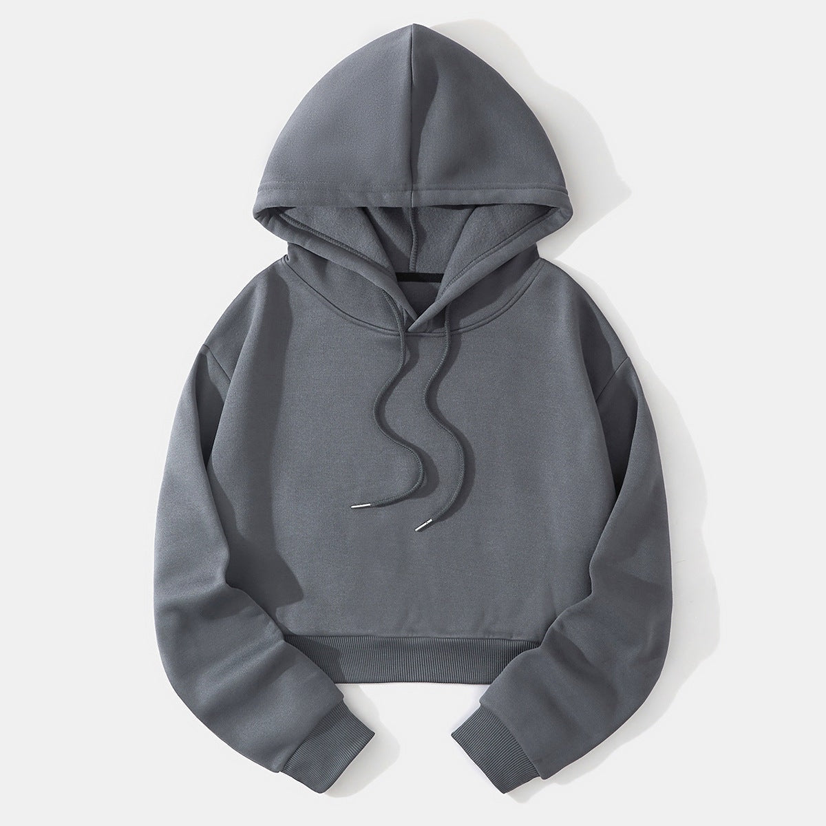 Charcoal gray cropped hoodie laid flat, highlighting the raised hood, long sleeves, ribbed waistband, and dark drawstrings.