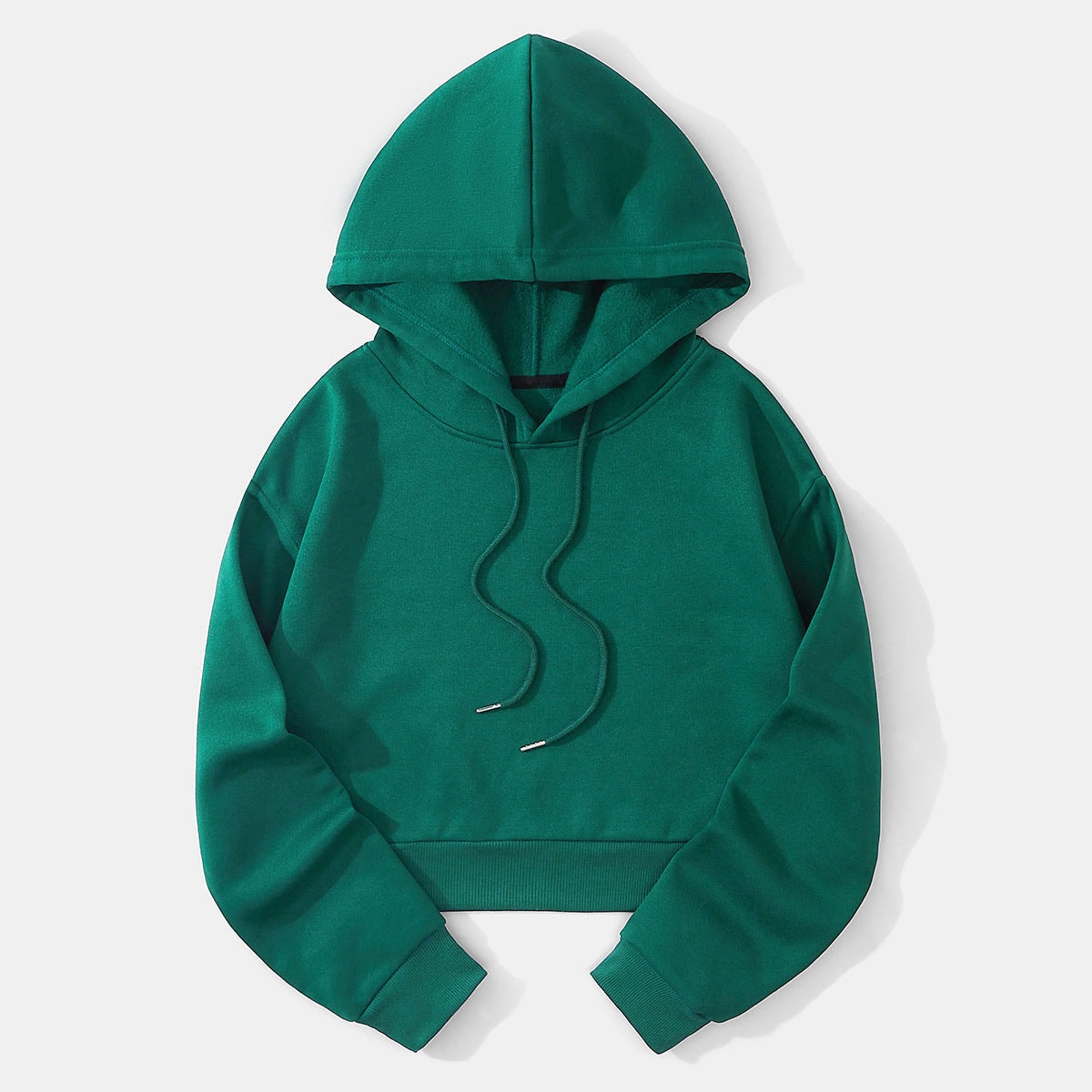 Deep teal cropped pullover hoodie shown flat with its raised hood, roomy sleeves, ribbed waistband, and front drawstrings.
