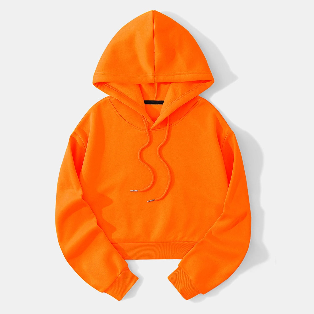 Bright orange cropped hoodie laid flat with the hood raised, long sleeves, ribbed cuffs, and adjustable drawstrings at the neckline.