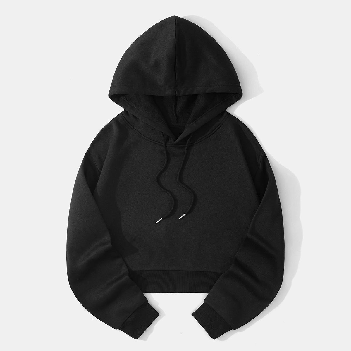 Black cropped pullover hoodie shown flat with its raised hood, contrasting drawstring tips, rounded sleeves, and ribbed waistband.