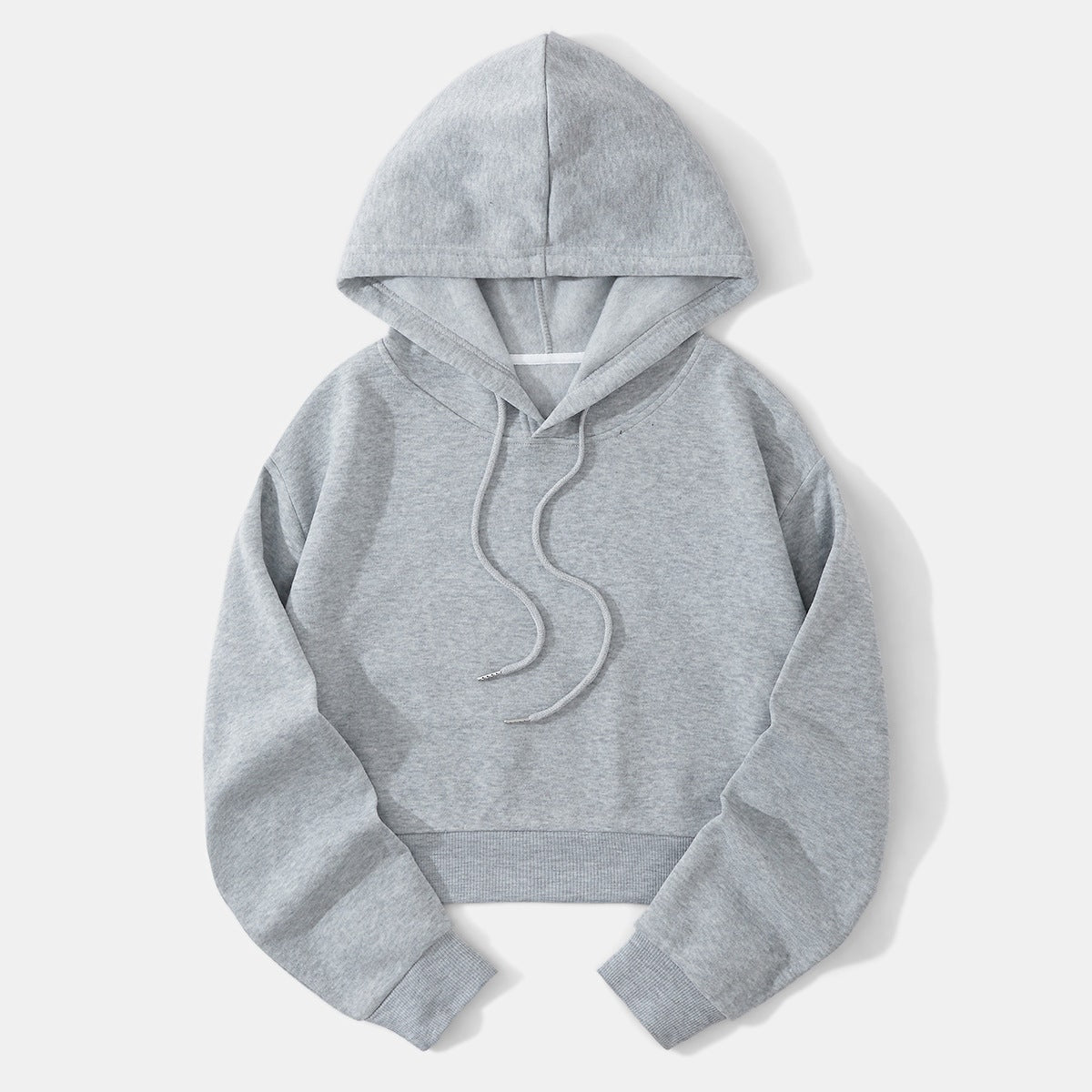 Light gray cropped hoodie laid flat with an open raised hood, long sleeves, front drawstrings, and a textured ribbed hem.