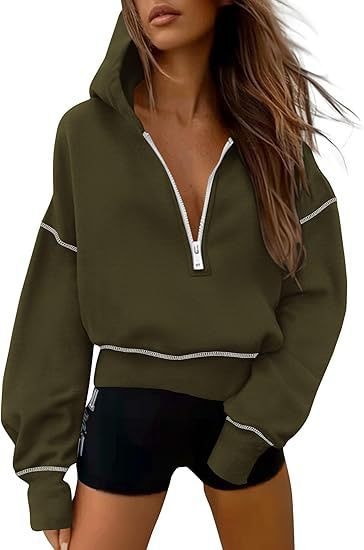 Dark olive cropped half-zip hoodie with a hood, white zipper, and white contrast stitching.