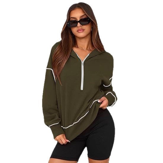 Olive green hooded half-zip top with white contrast trim, shown in a longer-looking styled view over black shorts.