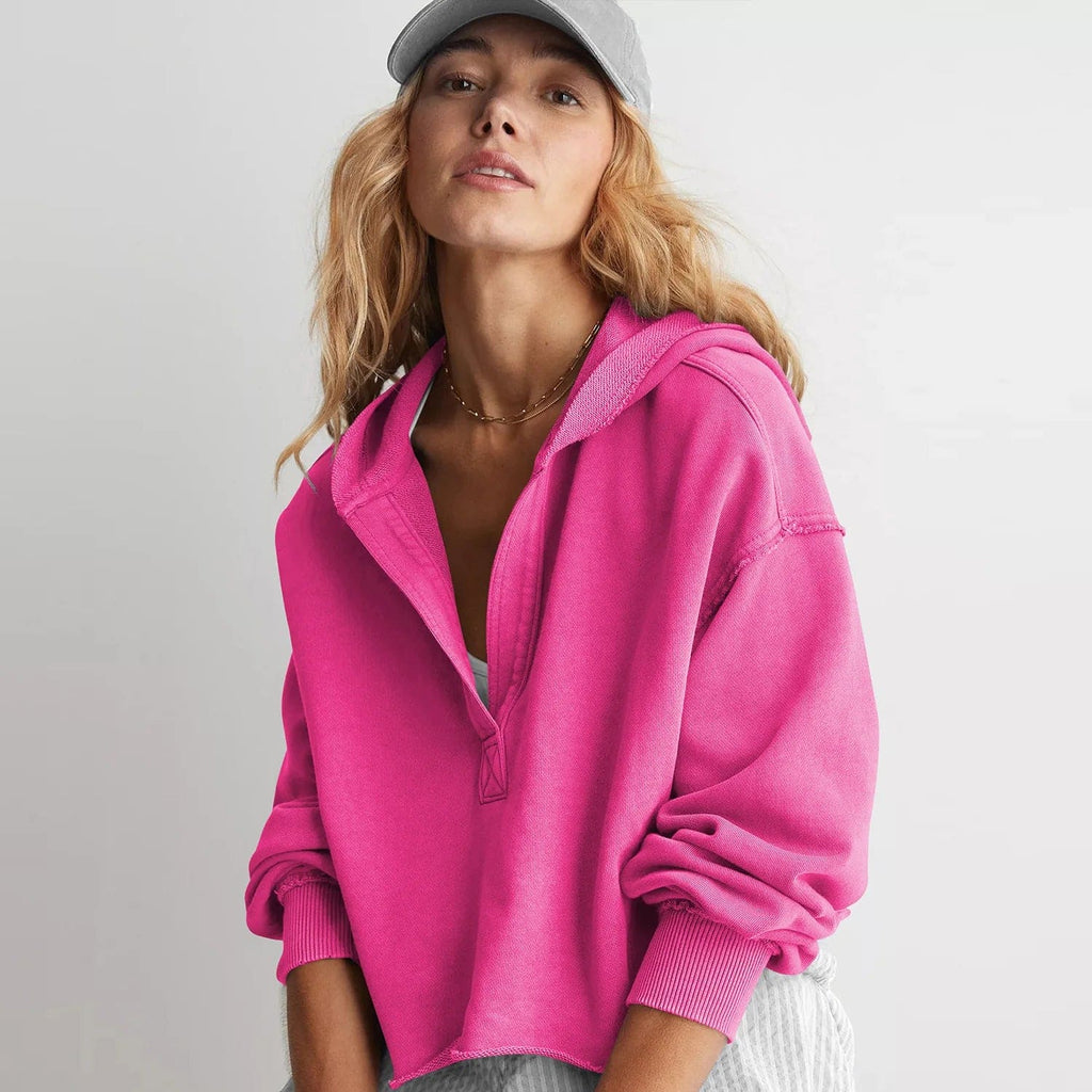 Woman wearing a relaxed cropped hoodie with collared neckline and long sleeves in a neutral indoor setting_13
