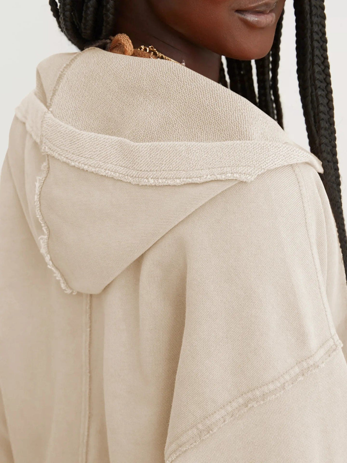 Woman wearing a relaxed cropped hoodie with collared neckline and long sleeves in a neutral indoor setting_39