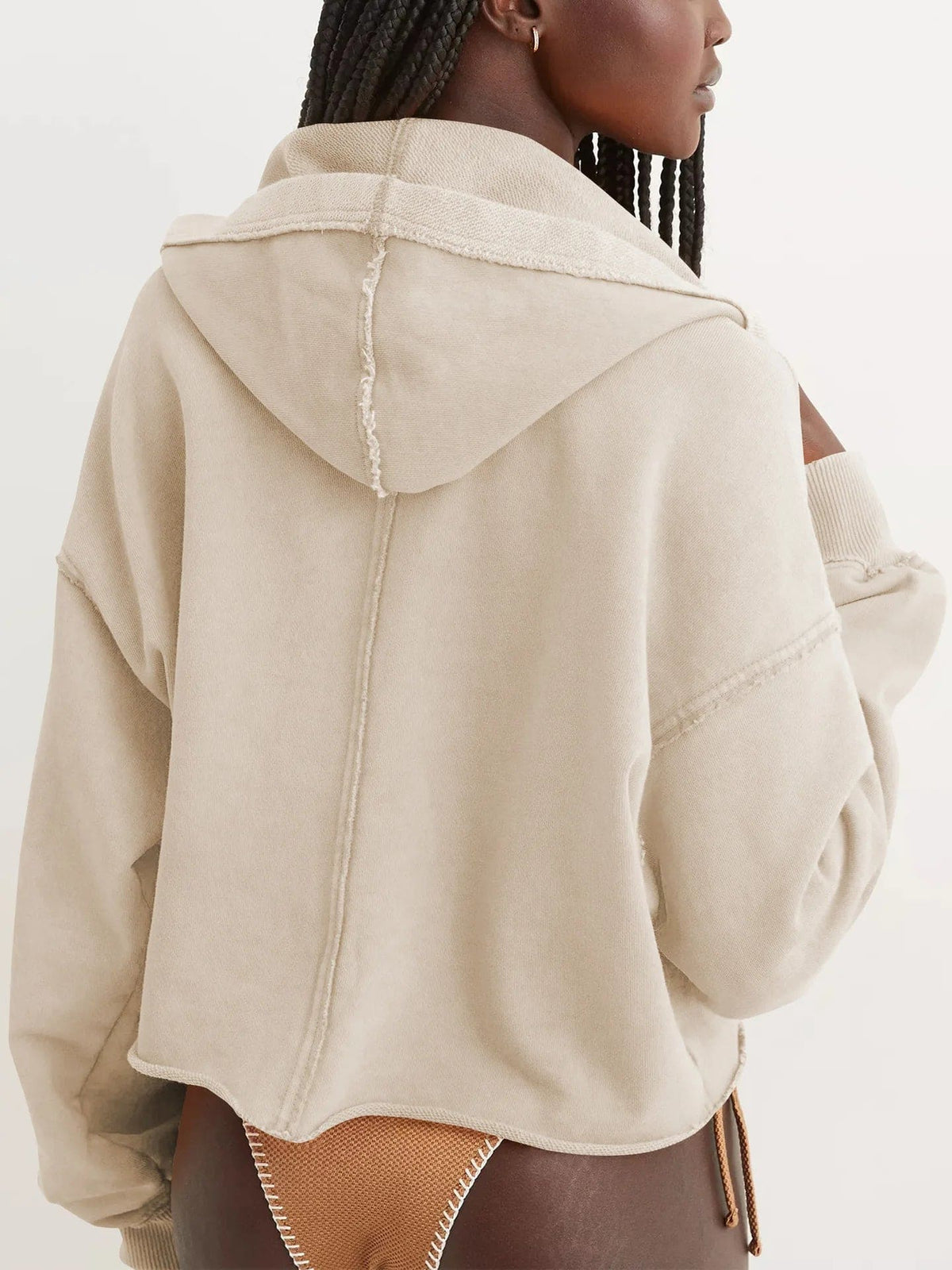 Woman wearing a relaxed cropped hoodie with collared neckline and long sleeves in a neutral indoor setting_40