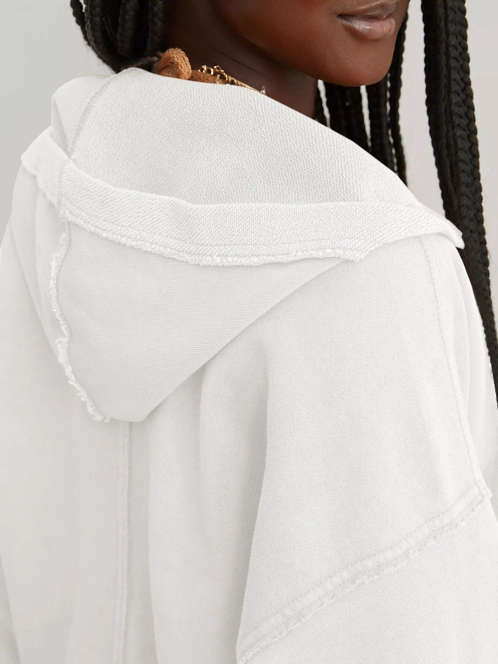Woman wearing a relaxed cropped hoodie with collared neckline and long sleeves in a neutral indoor setting_45