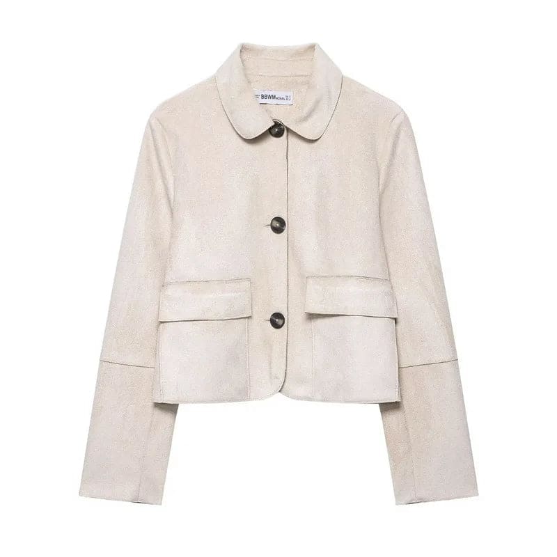 Woman wearing a cropped jacket with collared neckline, button front closure, and flap pockets over a black outfit._6