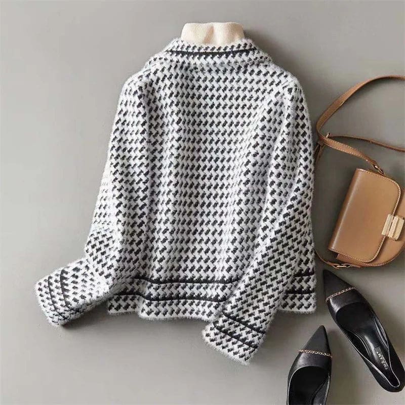 Woman wearing a cropped houndstooth knit jacket with double-breasted buttons over a black turtleneck._10