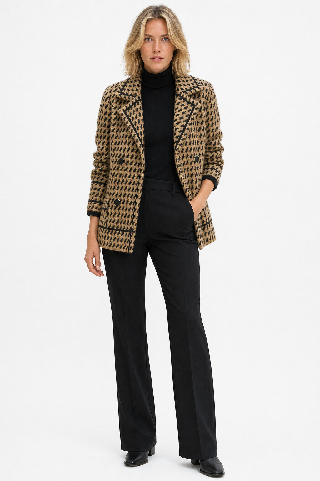 Woman wearing a cropped houndstooth knit jacket with double-breasted buttons over a black turtleneck._5