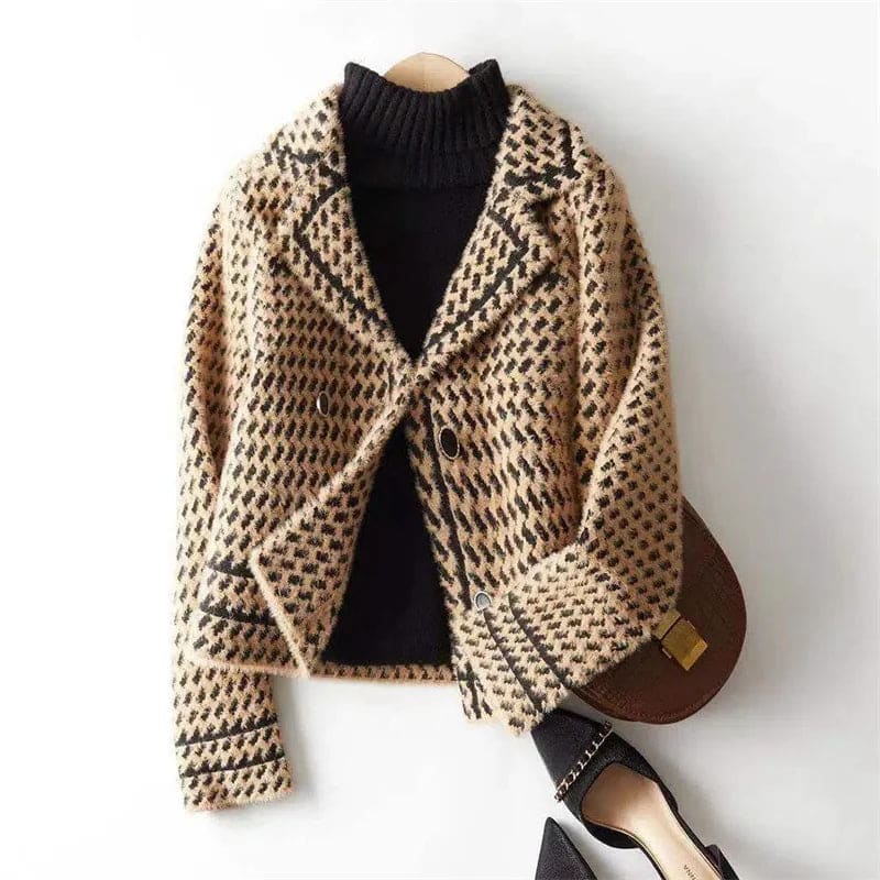 Woman wearing a cropped houndstooth knit jacket with double-breasted buttons over a black turtleneck._7