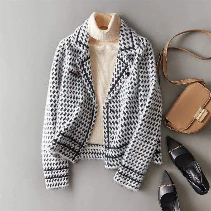 Woman wearing a cropped houndstooth knit jacket with double-breasted buttons over a black turtleneck._8