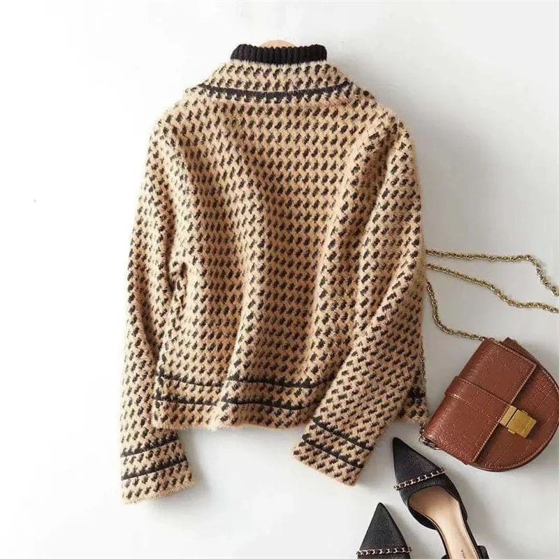 Woman wearing a cropped houndstooth knit jacket with double-breasted buttons over a black turtleneck._9