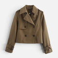 Cropped trench jacket in a neutral tone with double breasted button closure, notched lapel collar, shoulder epaulettes, and belted buckle cuffs displayed flat on a light background._0