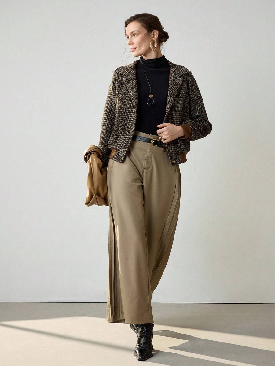 Woman wearing a cropped tweed blazer with houndstooth pattern over a black turtleneck and beige trousers._4