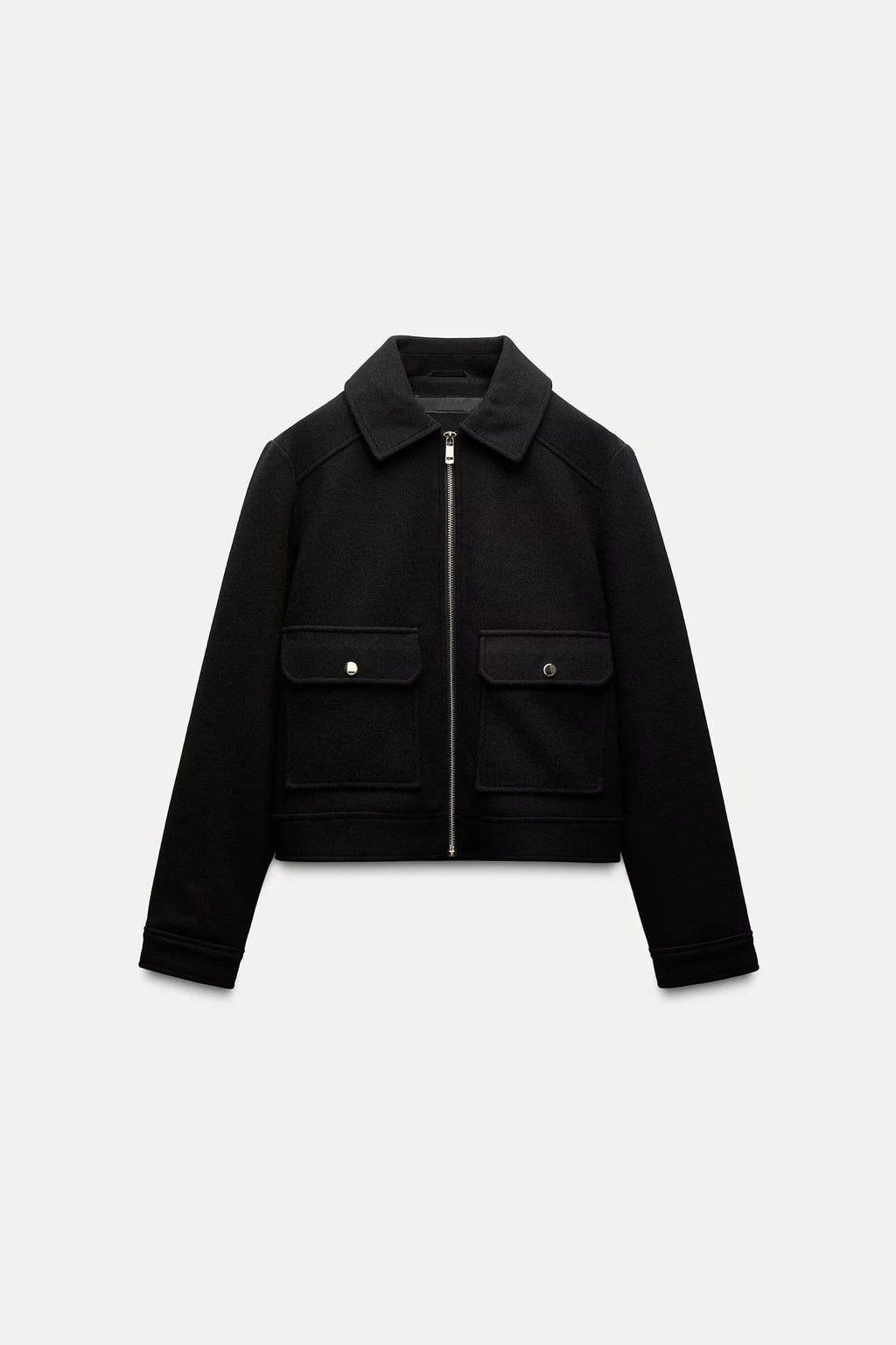 Woman wearing a cropped zip-front jacket with collar and chest pockets, styled over a light sweater and dark pants._9