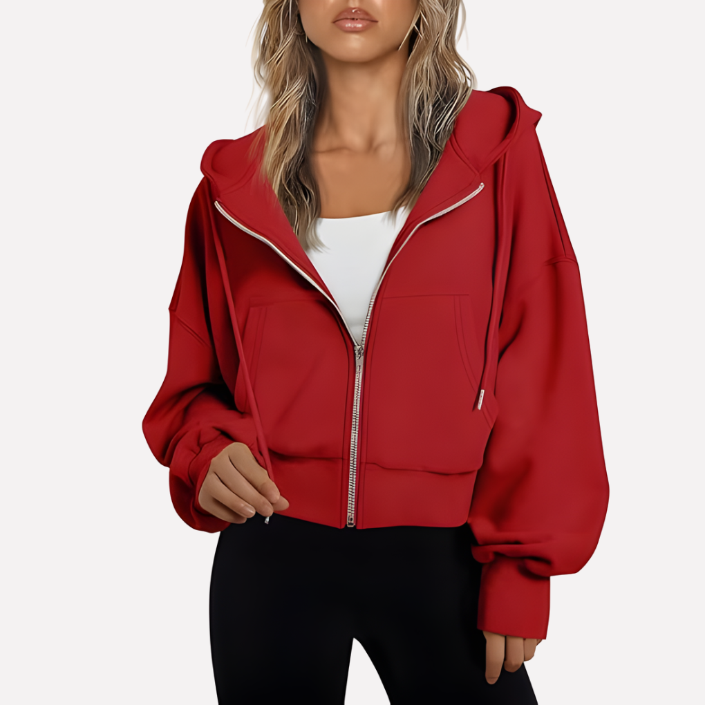 Red cropped zip-up hoodie featuring a drawstring hood, generous sleeves, front pockets, and ribbed cuffs and hem.