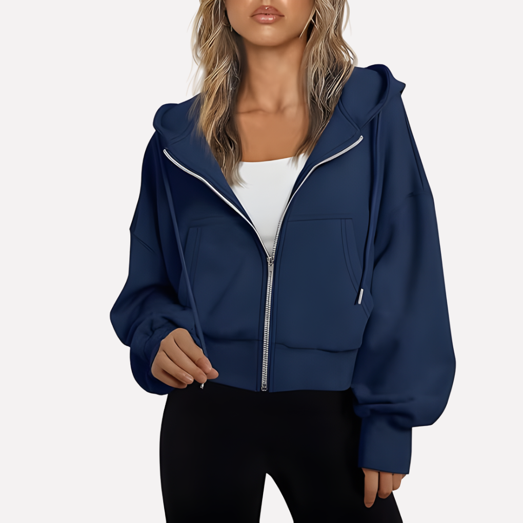 Navy cropped zip-up hoodie with a drawstring hood, voluminous sleeves, front pockets, and ribbed lower trim.