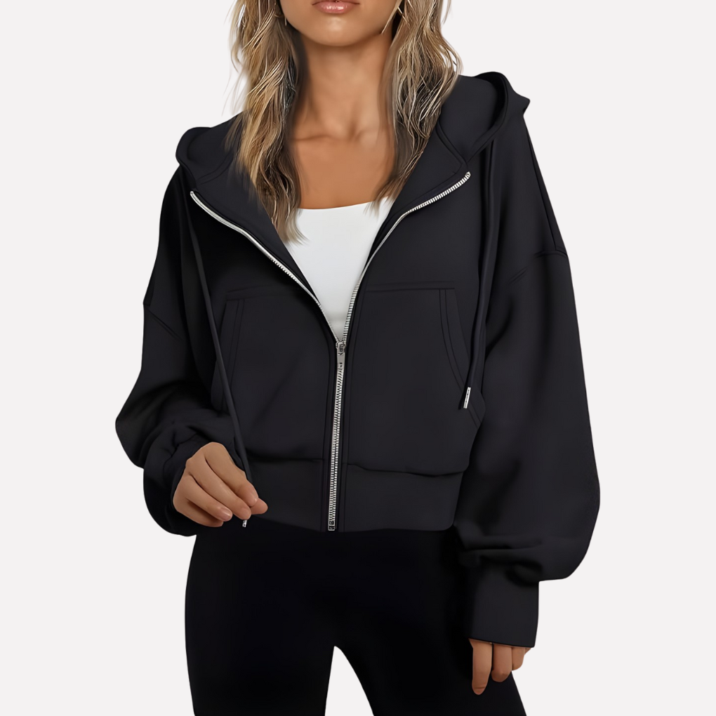 Black cropped hoodie with a zip front, drawstring hood, oversized sleeves, front pockets, and ribbed trim.