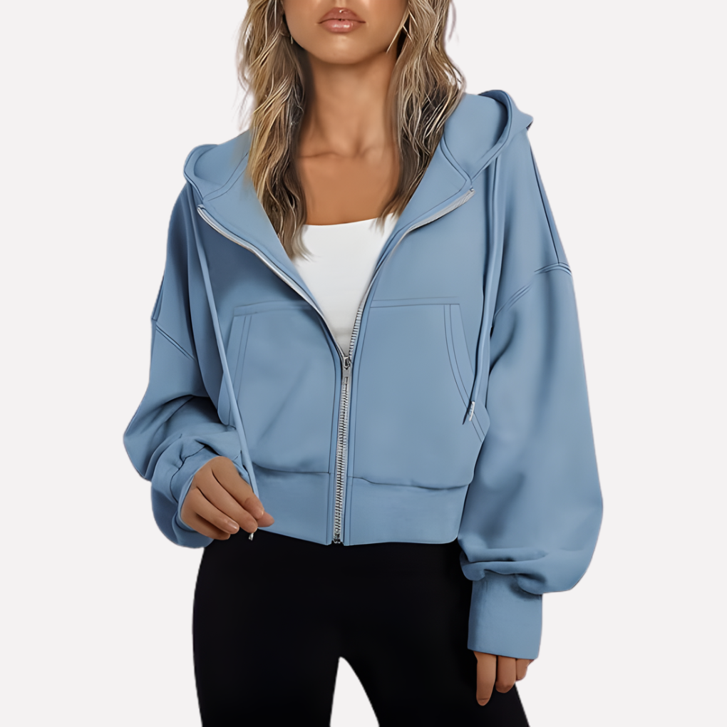 Light blue cropped zip-up hoodie featuring a drawstring hood, relaxed sleeves, front pockets, and ribbed cuffs and hem.