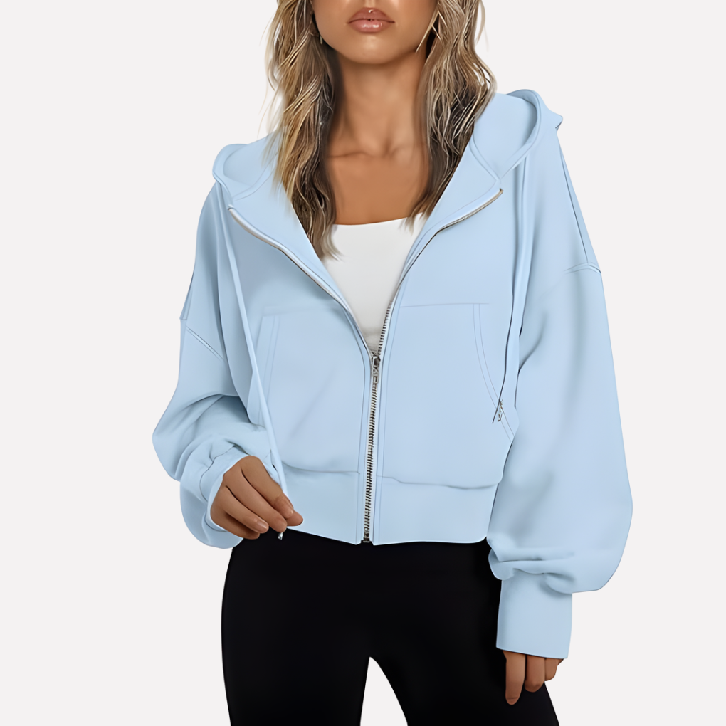 Pale blue cropped zip-up hoodie with an open hood, long drawstrings, spacious sleeves, and two front pockets.