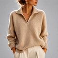 Woman wearing a beige ribbed oversized sweater with a folded collar and v-neckline, paired with cream trousers._0