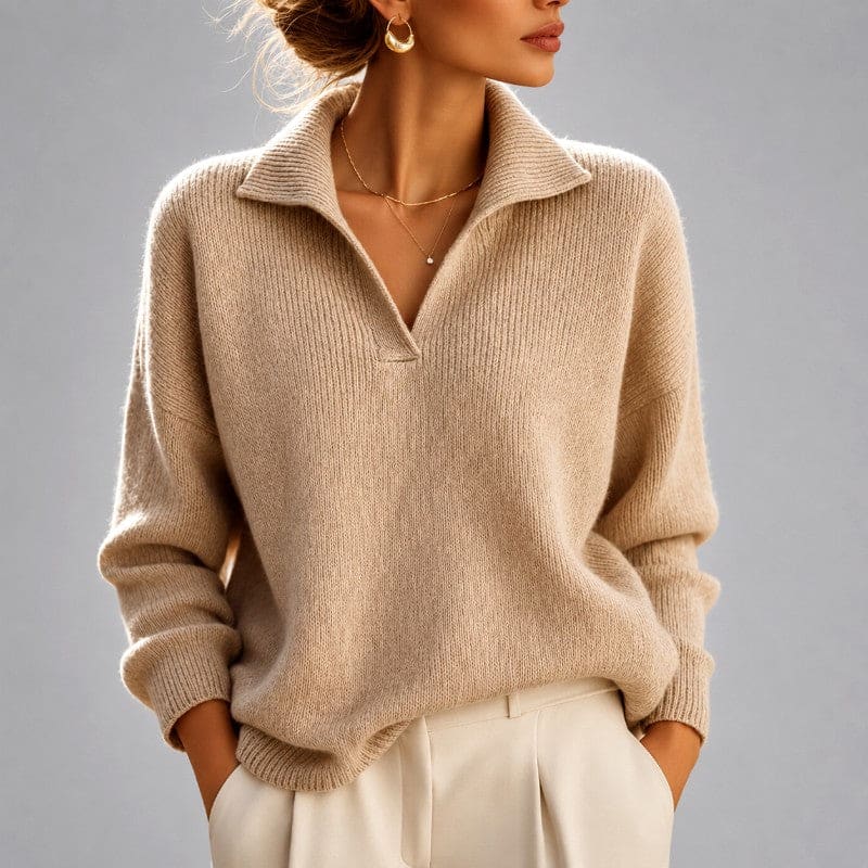 Woman wearing a beige ribbed oversized sweater with a folded collar and v-neckline, paired with cream trousers._0