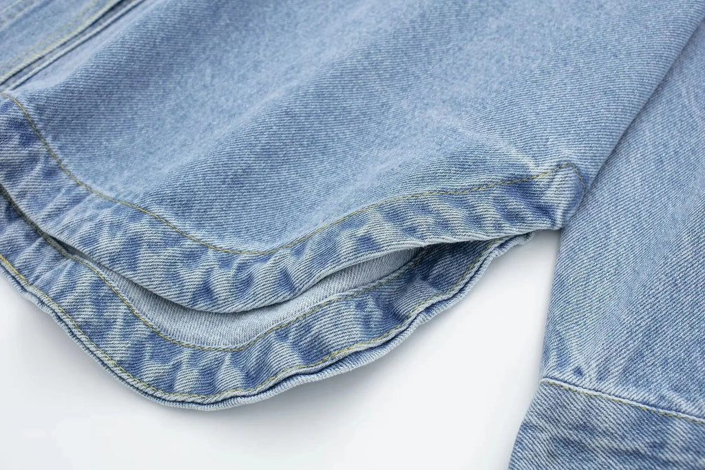 Woman wearing an oversized denim shirt jacket with button front, styled with matching jeans and neutral background._13