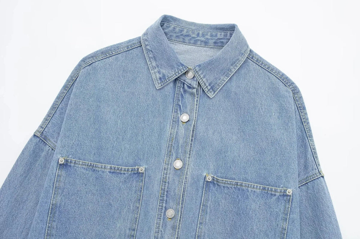 Woman wearing an oversized denim shirt jacket with button front, styled with matching jeans and neutral background._14