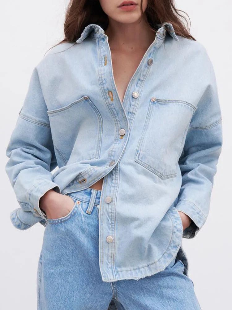 Woman wearing an oversized denim shirt jacket with button front, styled with matching jeans and neutral background._6
