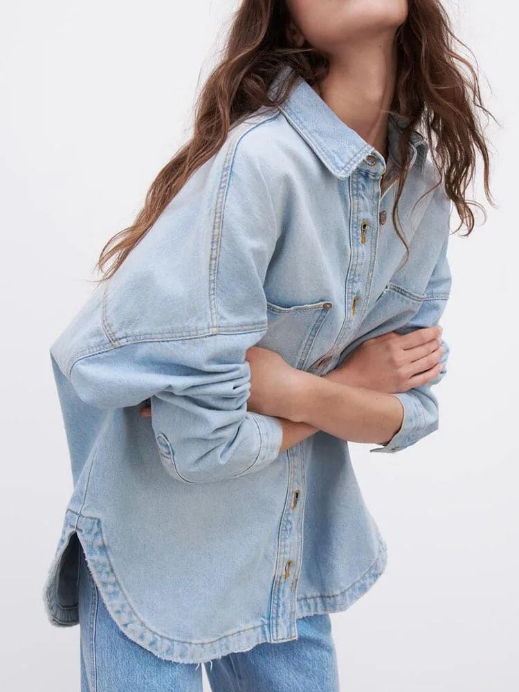 Woman wearing an oversized denim shirt jacket with button front, styled with matching jeans and neutral background._7