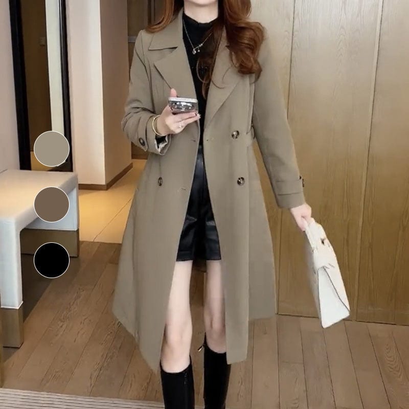 Woman wearing a longline double-breasted trench coat with lapel collar and belted waist in an indoor setting._5
