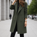 Woman wearing a double-breasted midi coat in olive green with notched lapel, paired with black clothing on an urban street._0