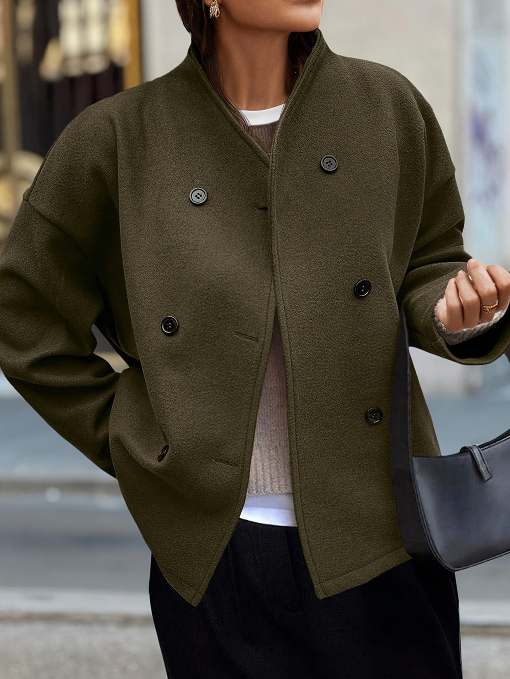 Woman wearing a stand collar pea coat with double breasted button front and relaxed fit over casual layers._0