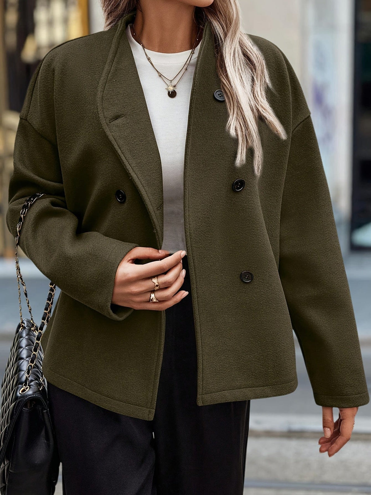 Woman wearing a stand collar pea coat with double breasted button front and relaxed fit over casual layers._1