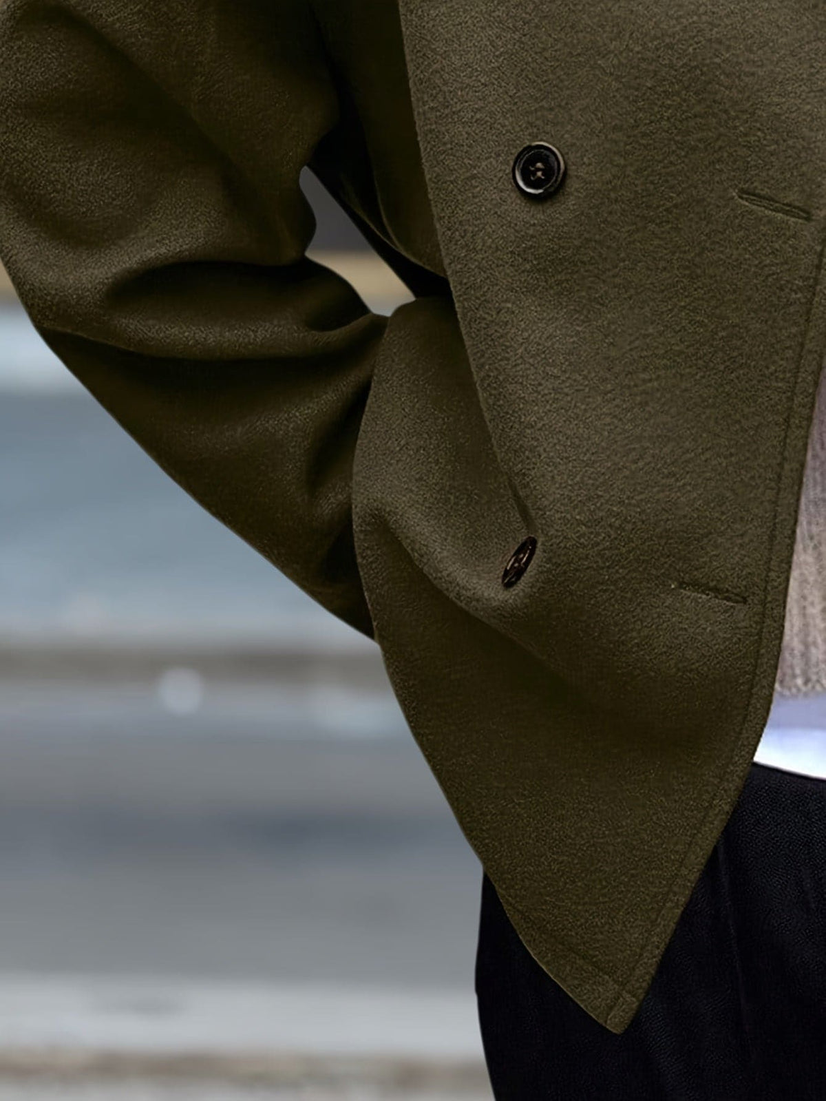 Woman wearing a stand collar pea coat with double breasted button front and relaxed fit over casual layers._4