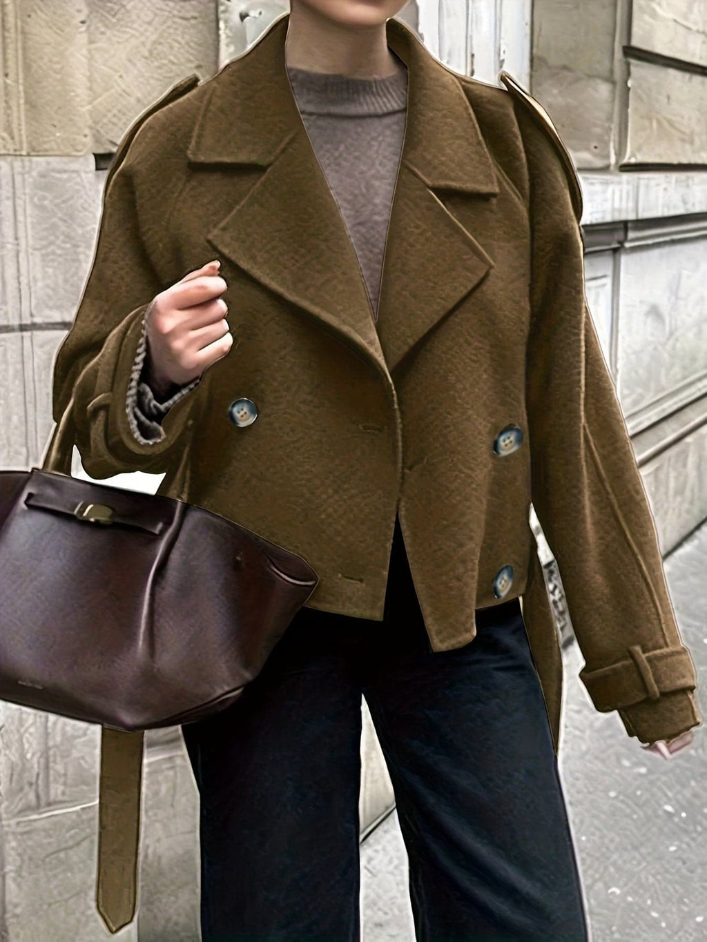 Woman wearing an olive green double breasted pea coat with notch lapel and tie belt over black outfit on city street_2